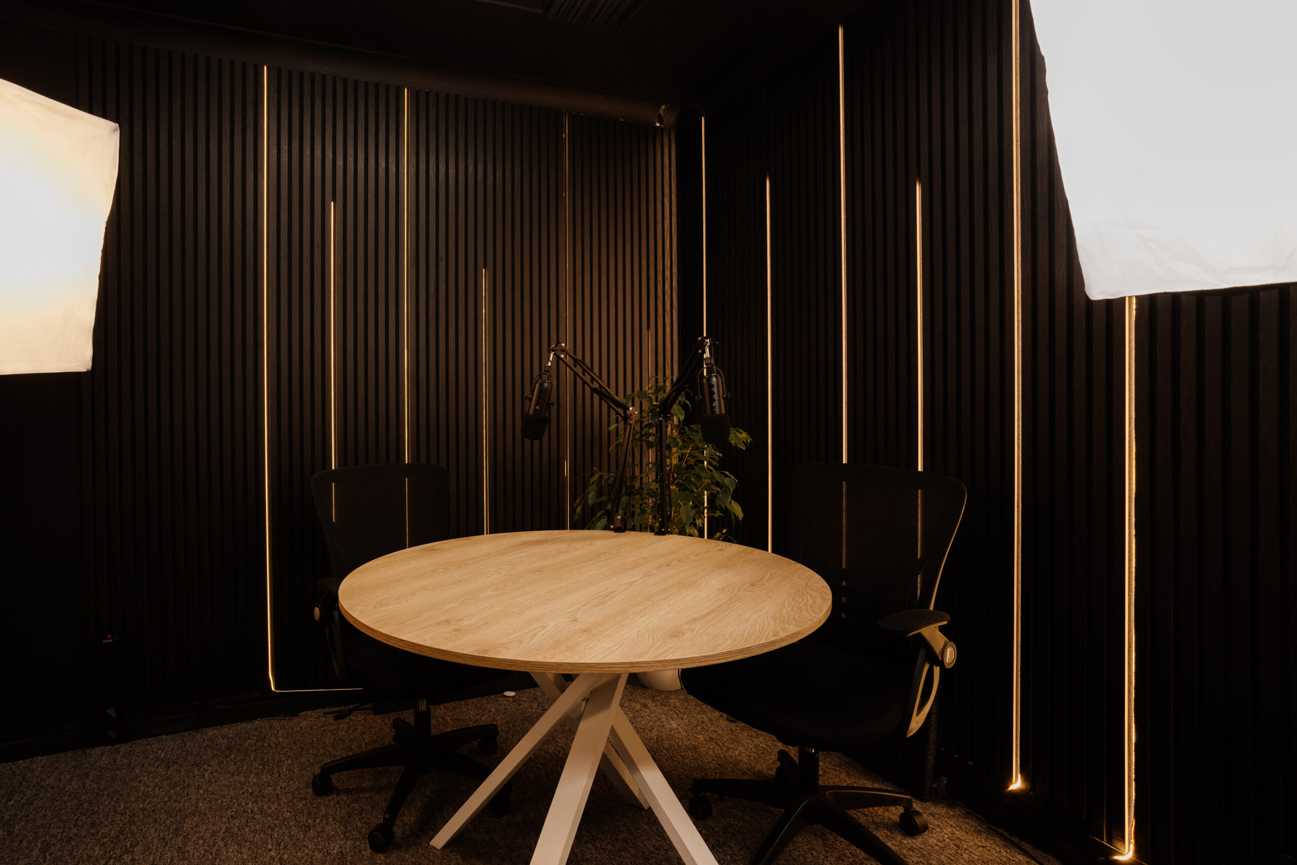 Hero view of the podcast studio with full recording set and lighting