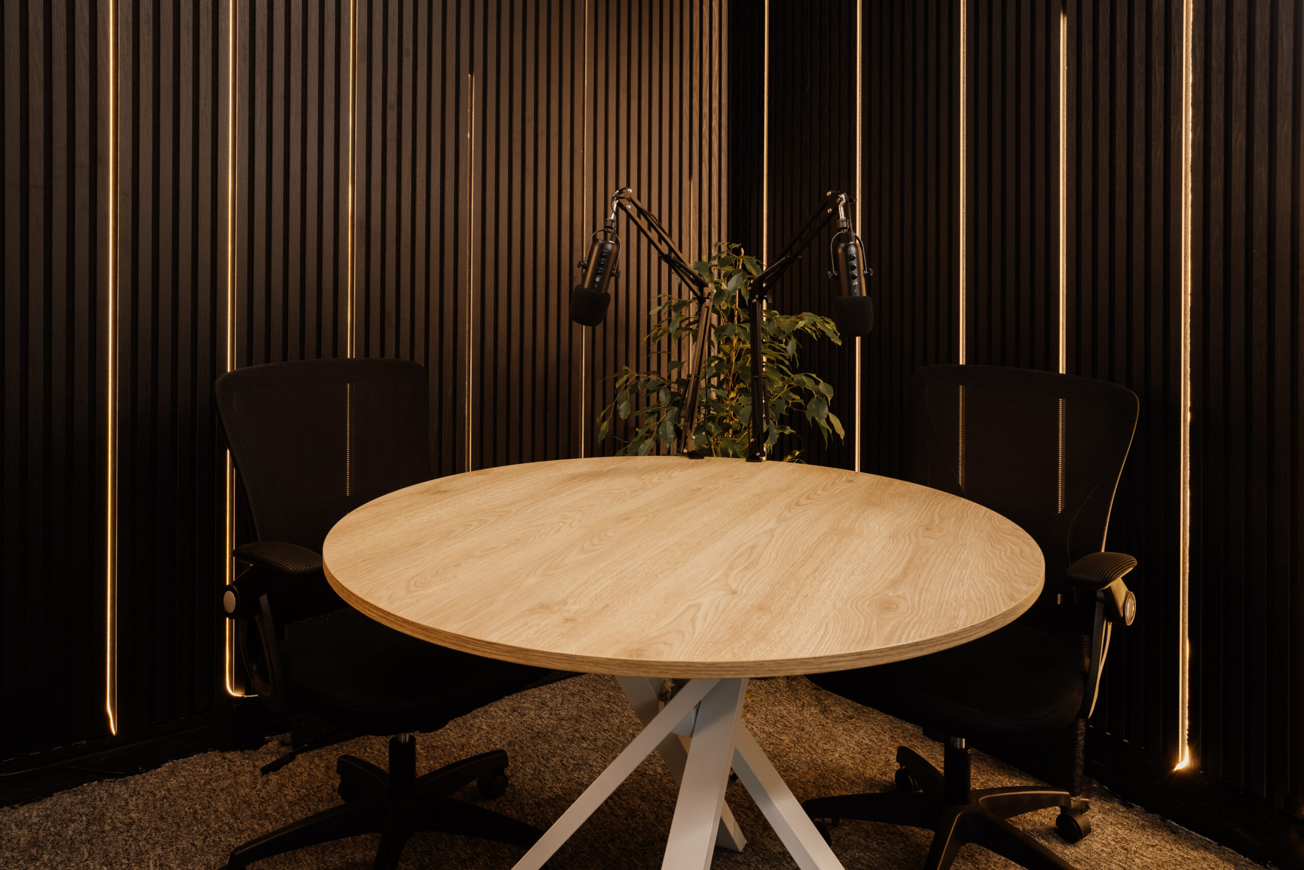 Podcast recording area with studio furniture, microphones, and production equipment